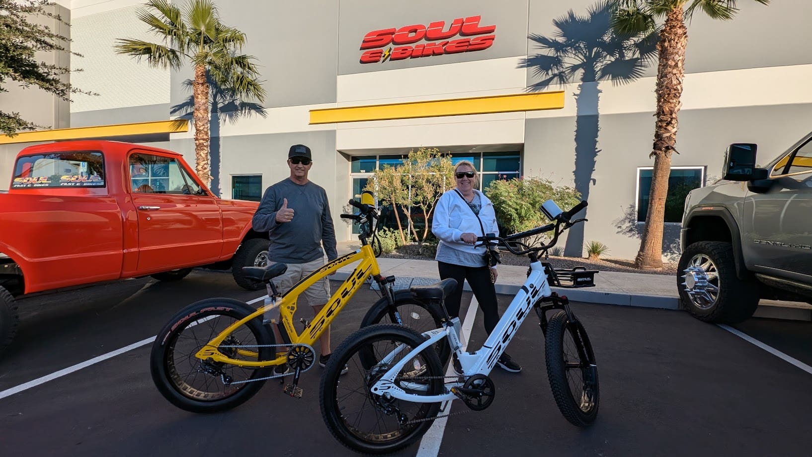People with electric bikes outside a store.