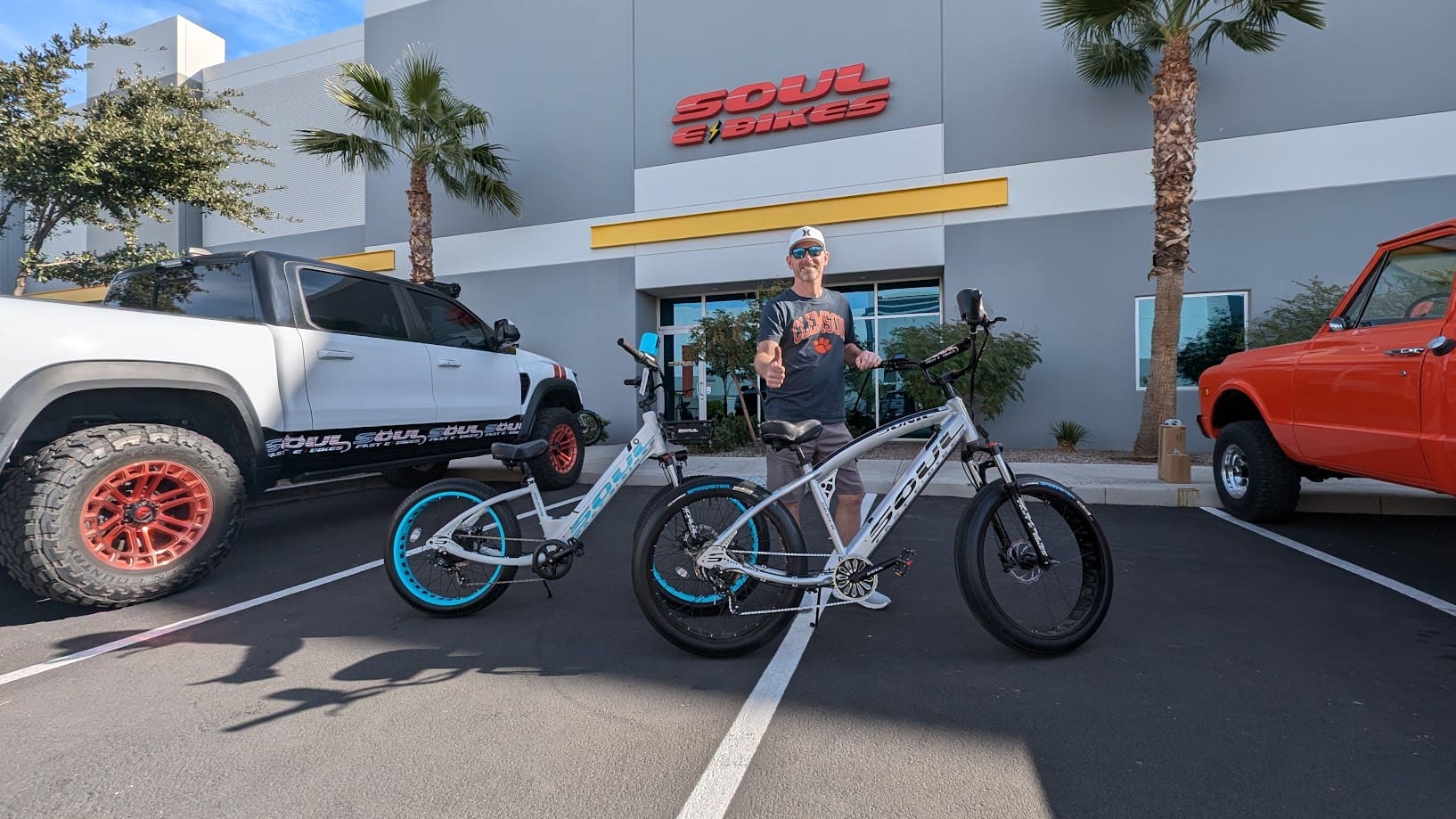 Man posing with bikes outside Soul e Bikes.