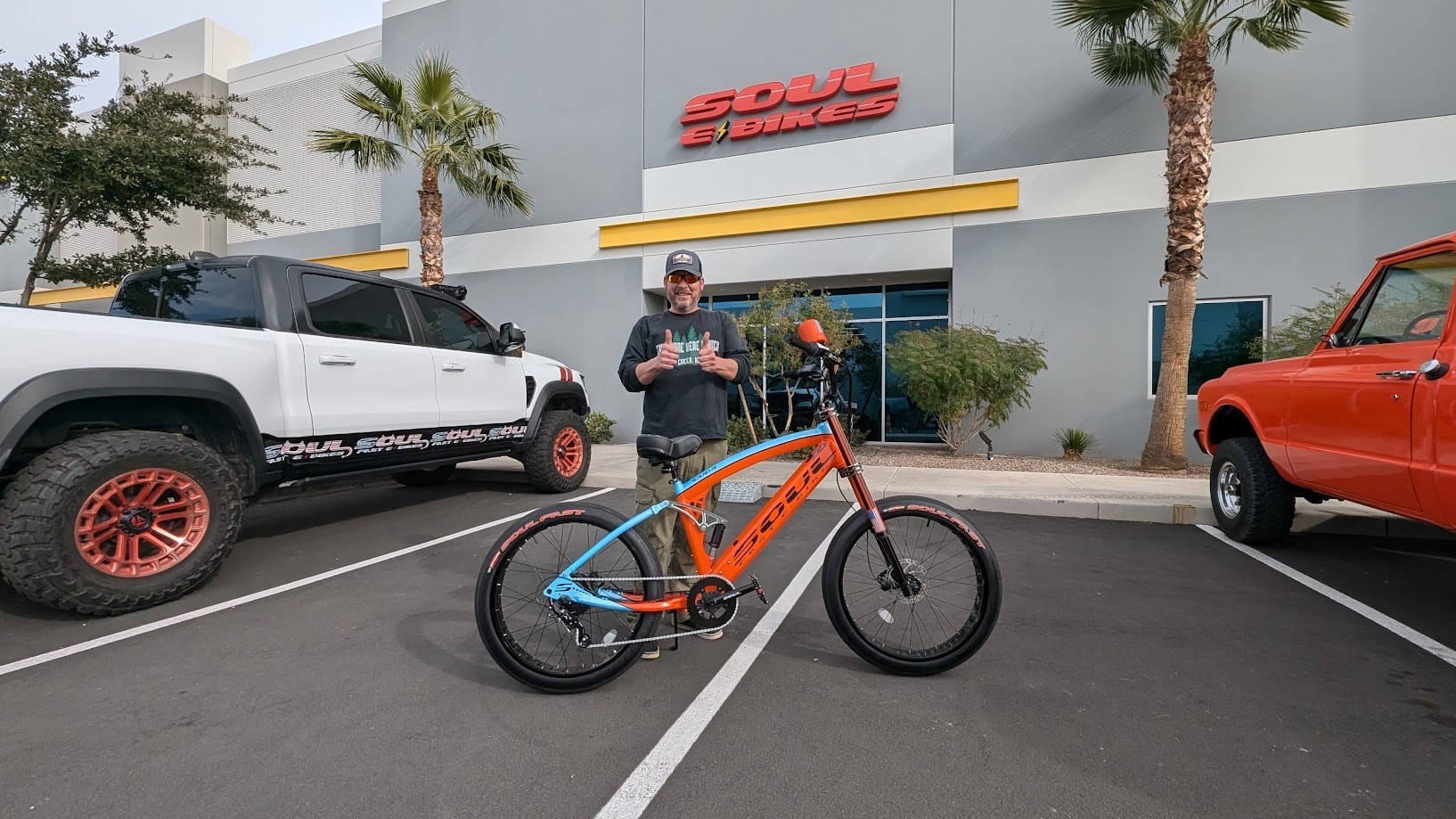 Man with bike in parking lot.
