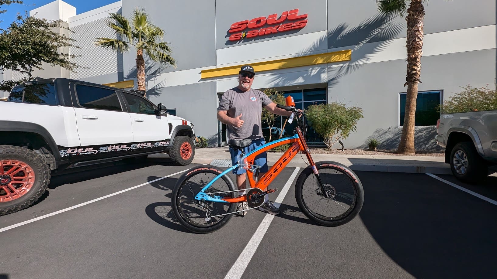 Man with bicycle outside Soul e Bikes store.