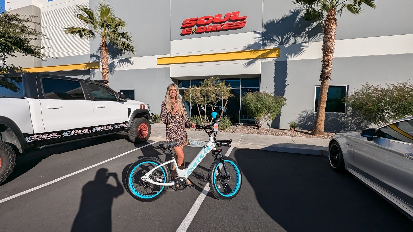 Woman posing with bicycle outside Soul building.