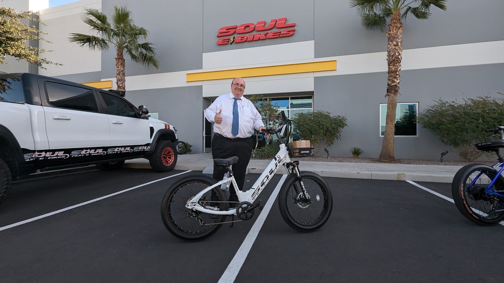 Man posing with bicycle outside Soul Bikes store.