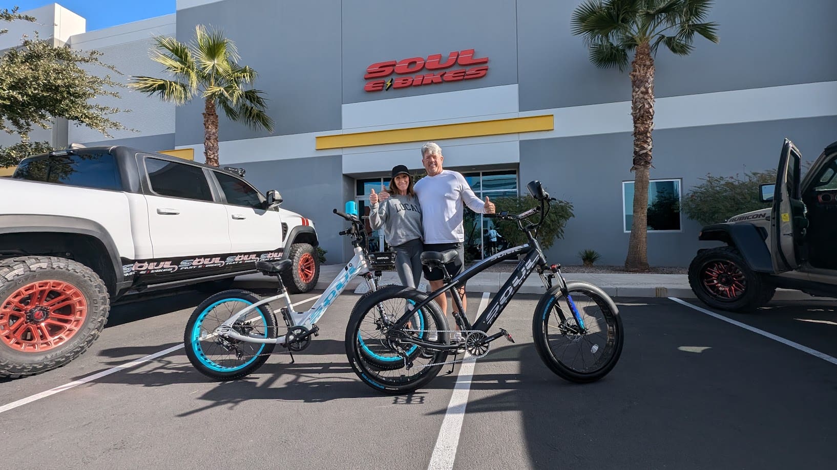 Couple with bikes outside Soul Bikes shop.