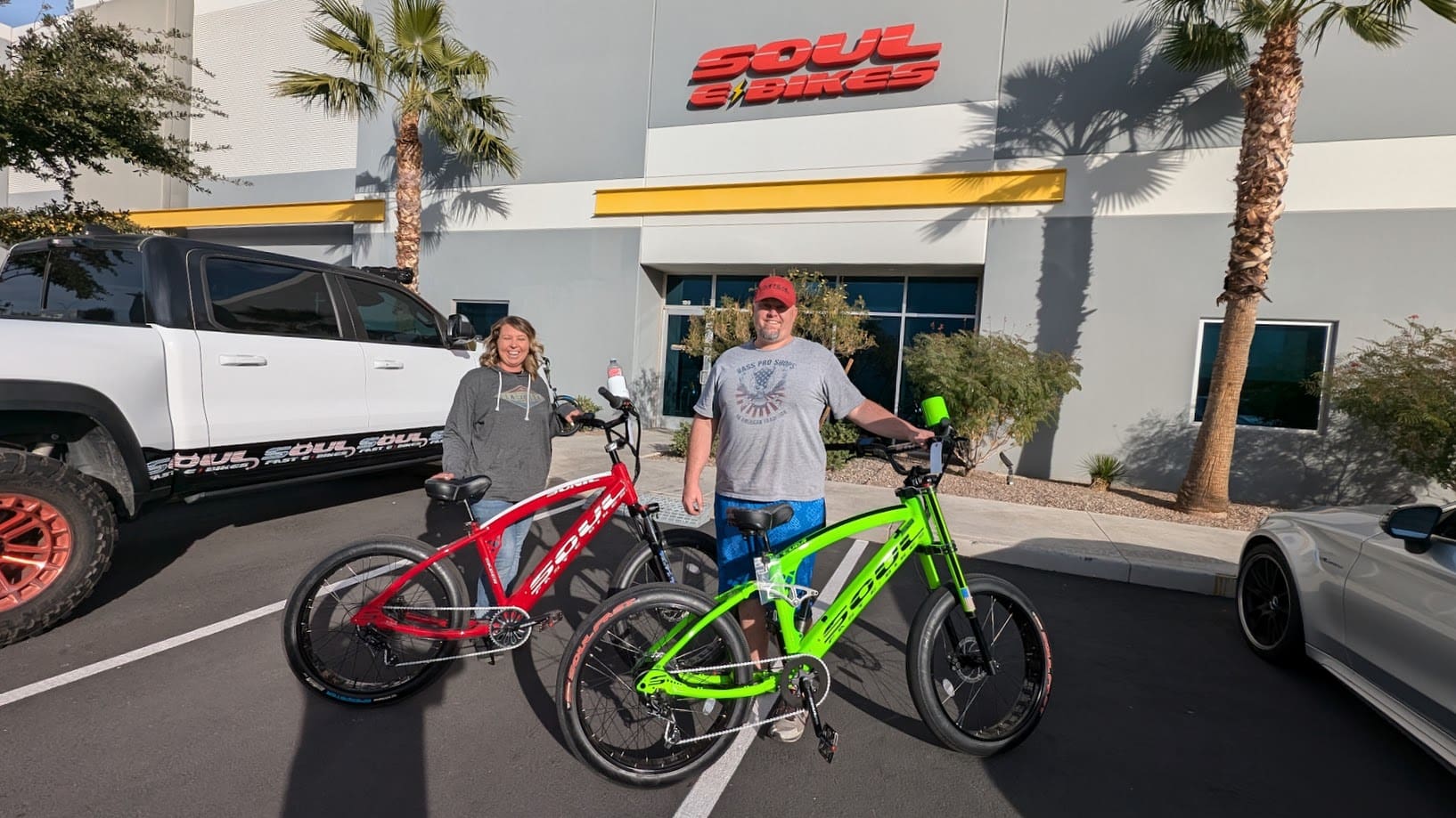 Two people with bicycles outside Soul Bikes.