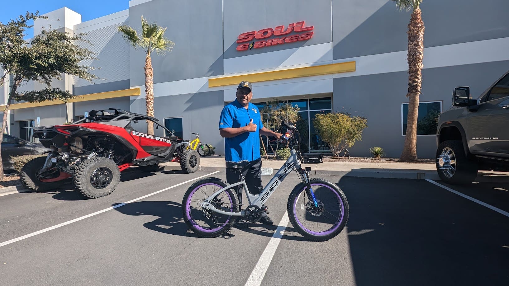 Man posing with bicycle outside Soul Cycles building.