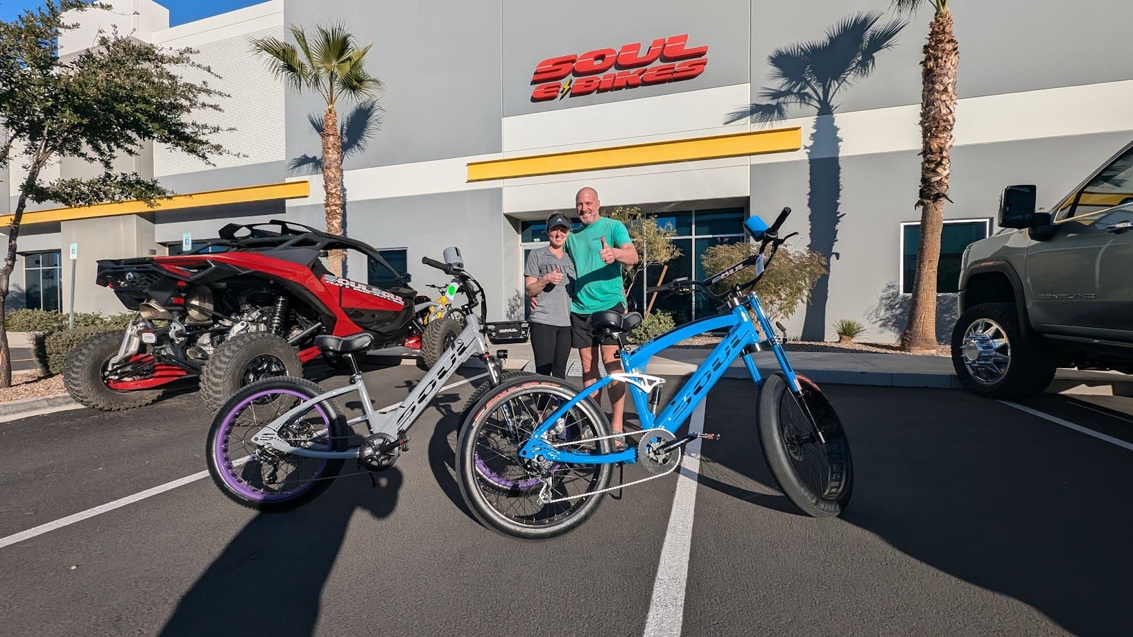People with bikes outside a store building.