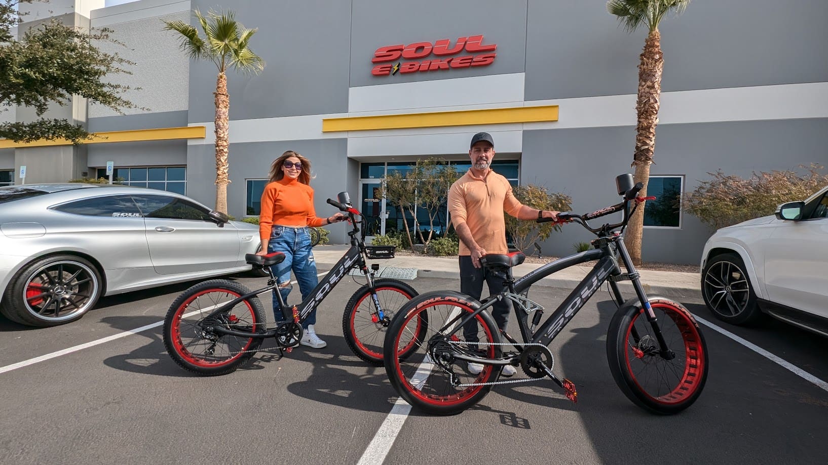 Two people with bicycles outside Soul Bikes.