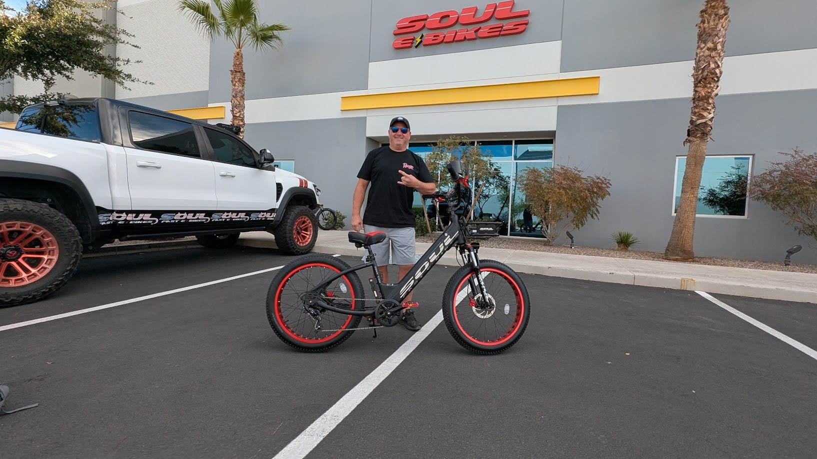 Man standing with bike outside Soul eBikes.