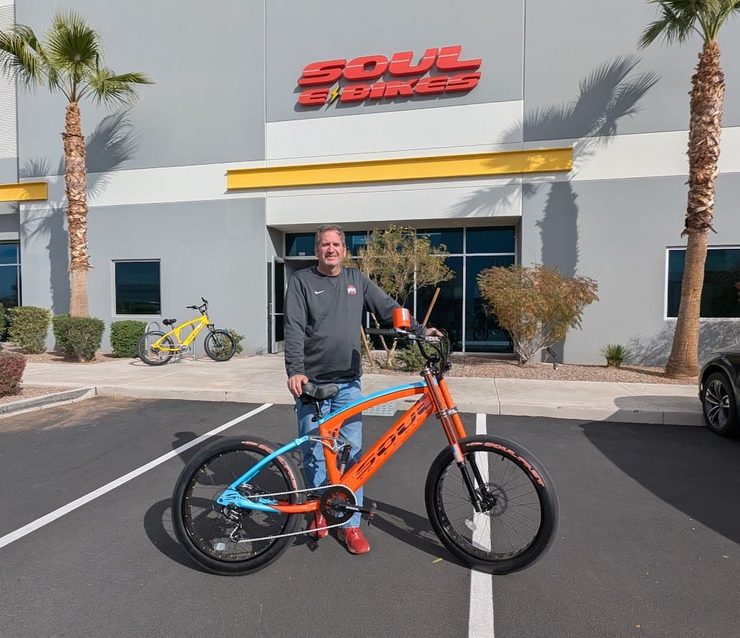 Man standing with bike outside Soul eBikes.