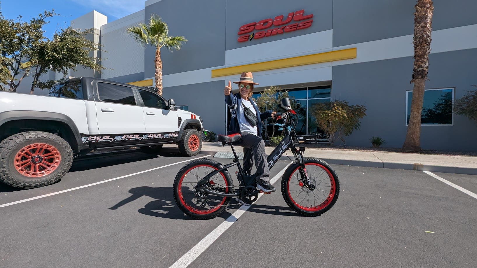 Person on bike outside a store.