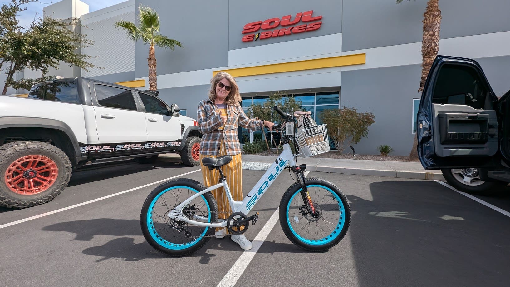 Person holding bicycle outside Soul eBikes store.