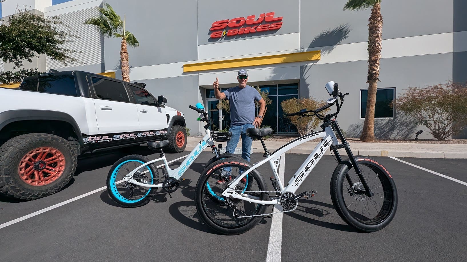 Man with bicycles outside Soul eBikes building.