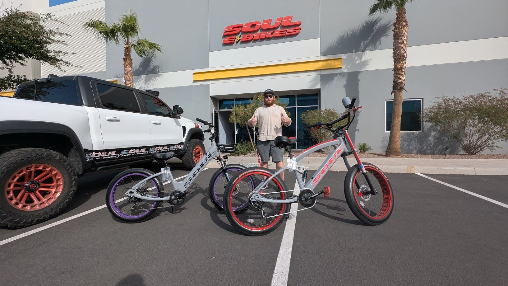 Man with bicycles in front of Soul Bikes.
