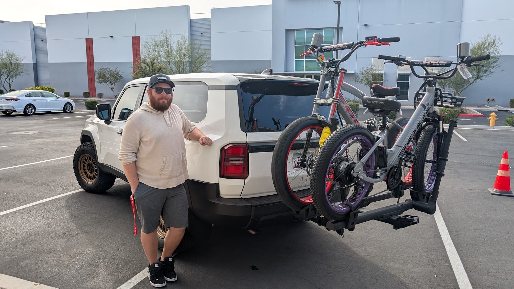Man standing by SUV with bike rack.