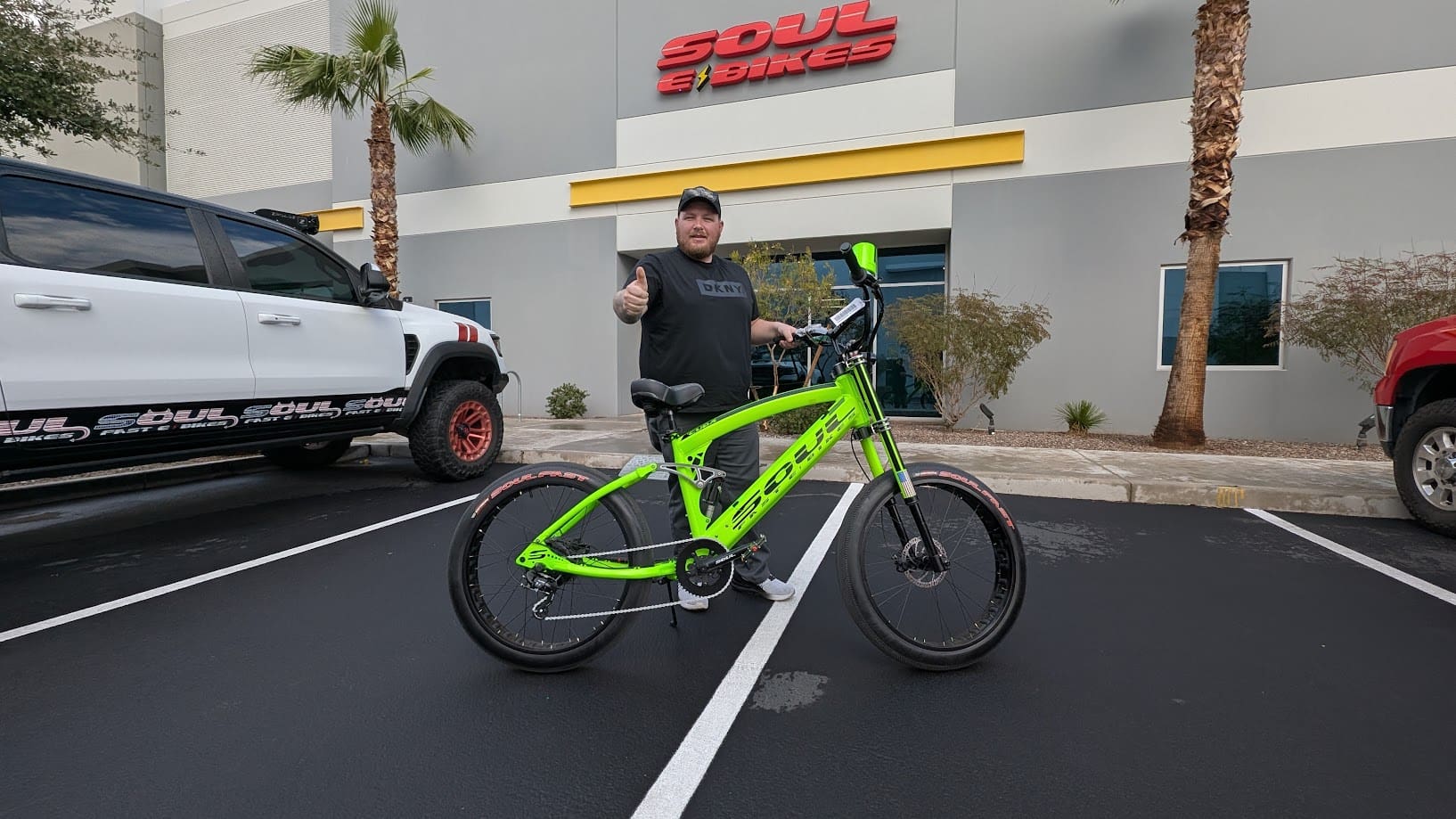 Man with green bike outside Soul Bikes shop.