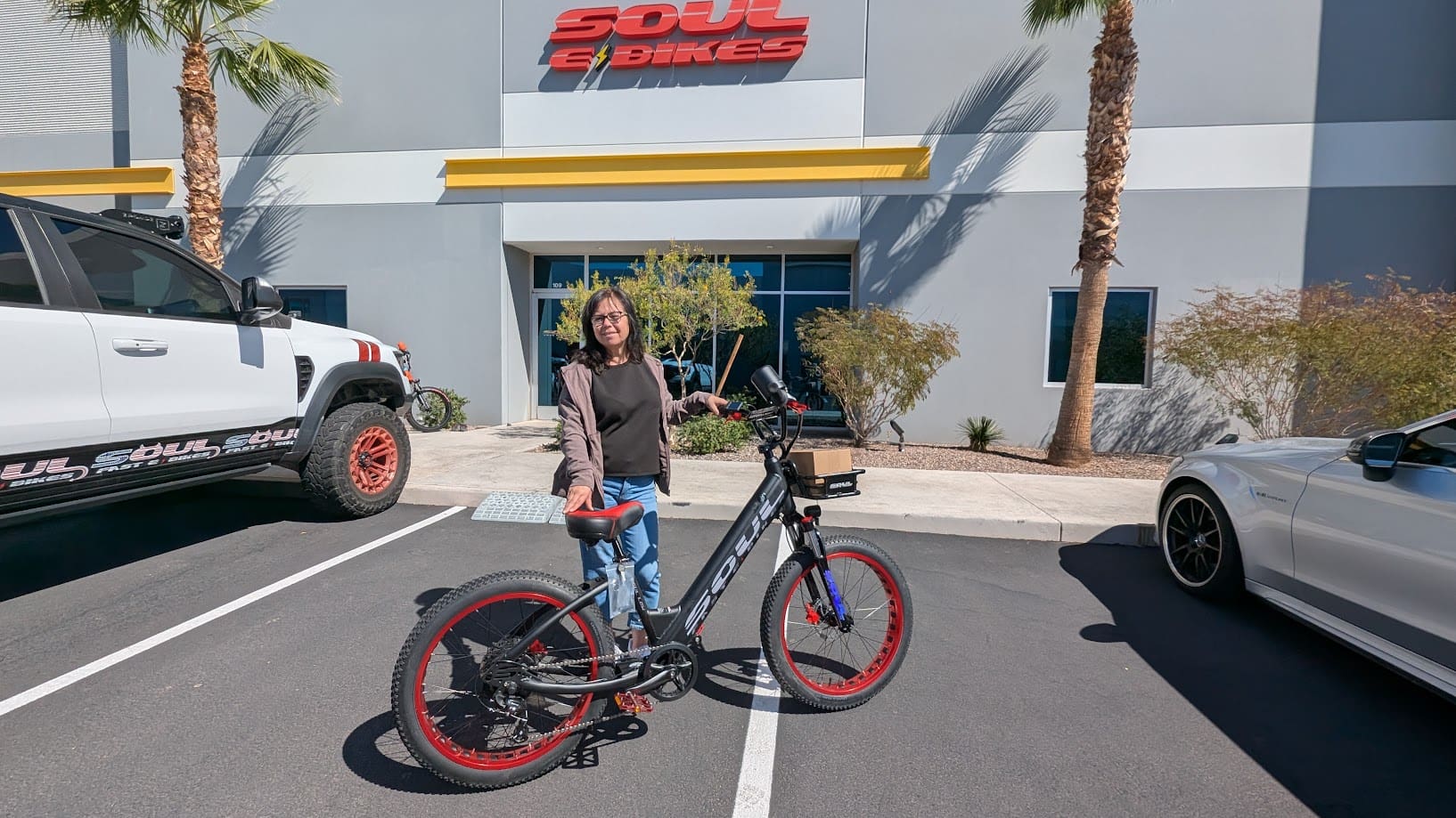 Person with bicycle outside a building.