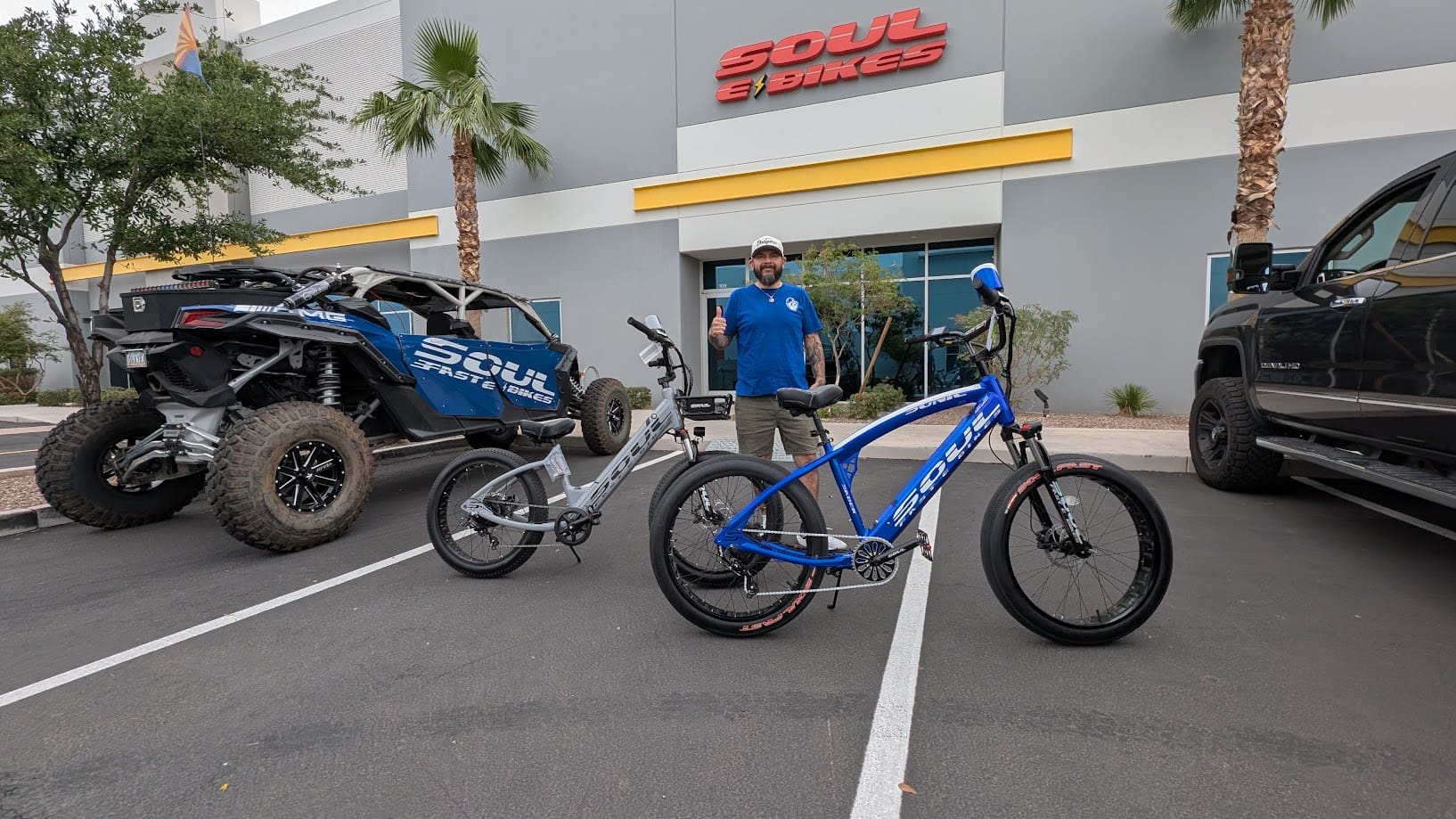 Bicycles and off-road vehicle in parking lot.