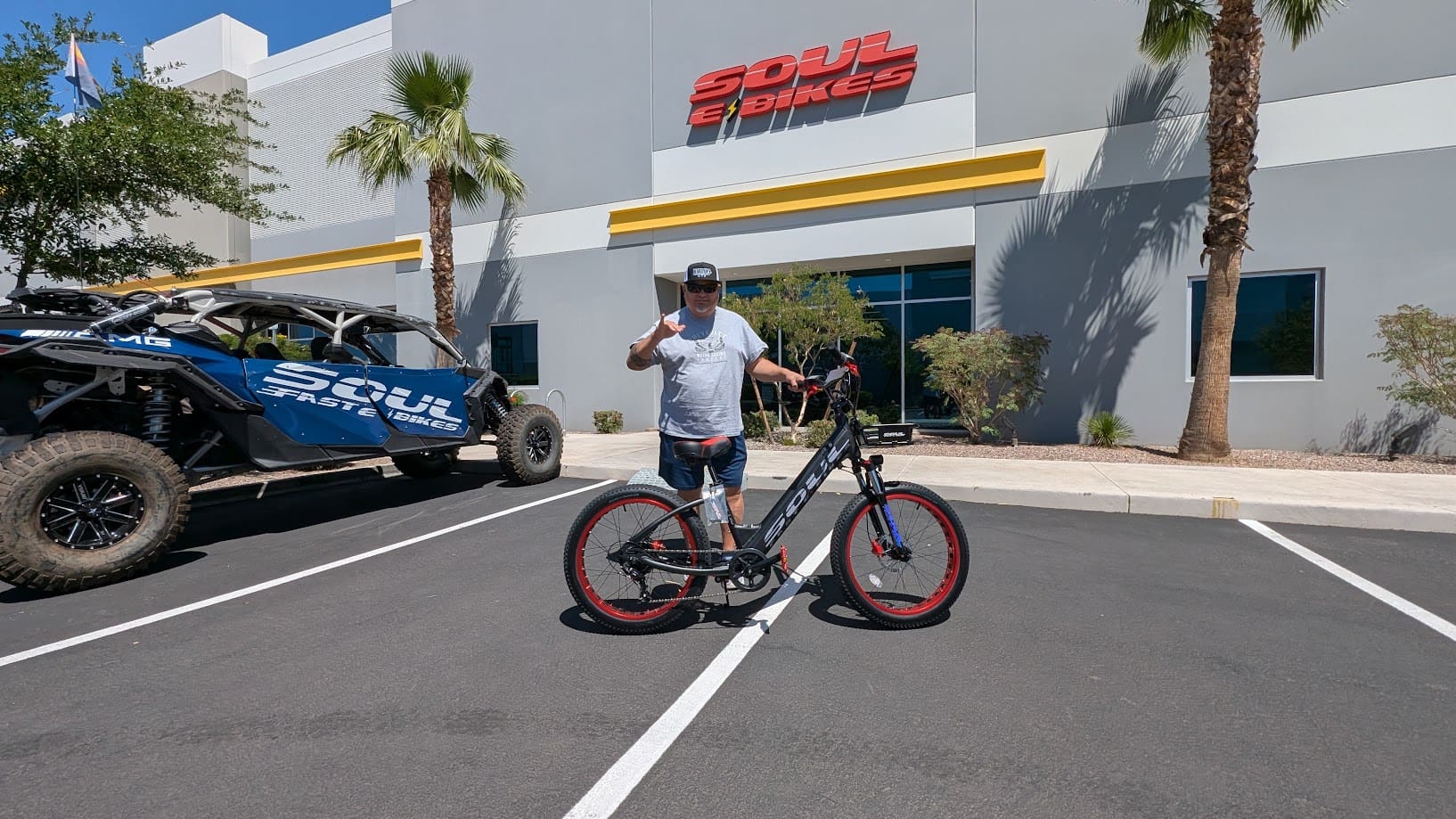 Man standing with bicycle outside Soul Bikes.