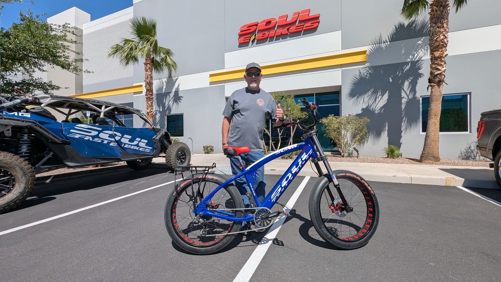 Man with blue electric bike outside Soul E Bikes.