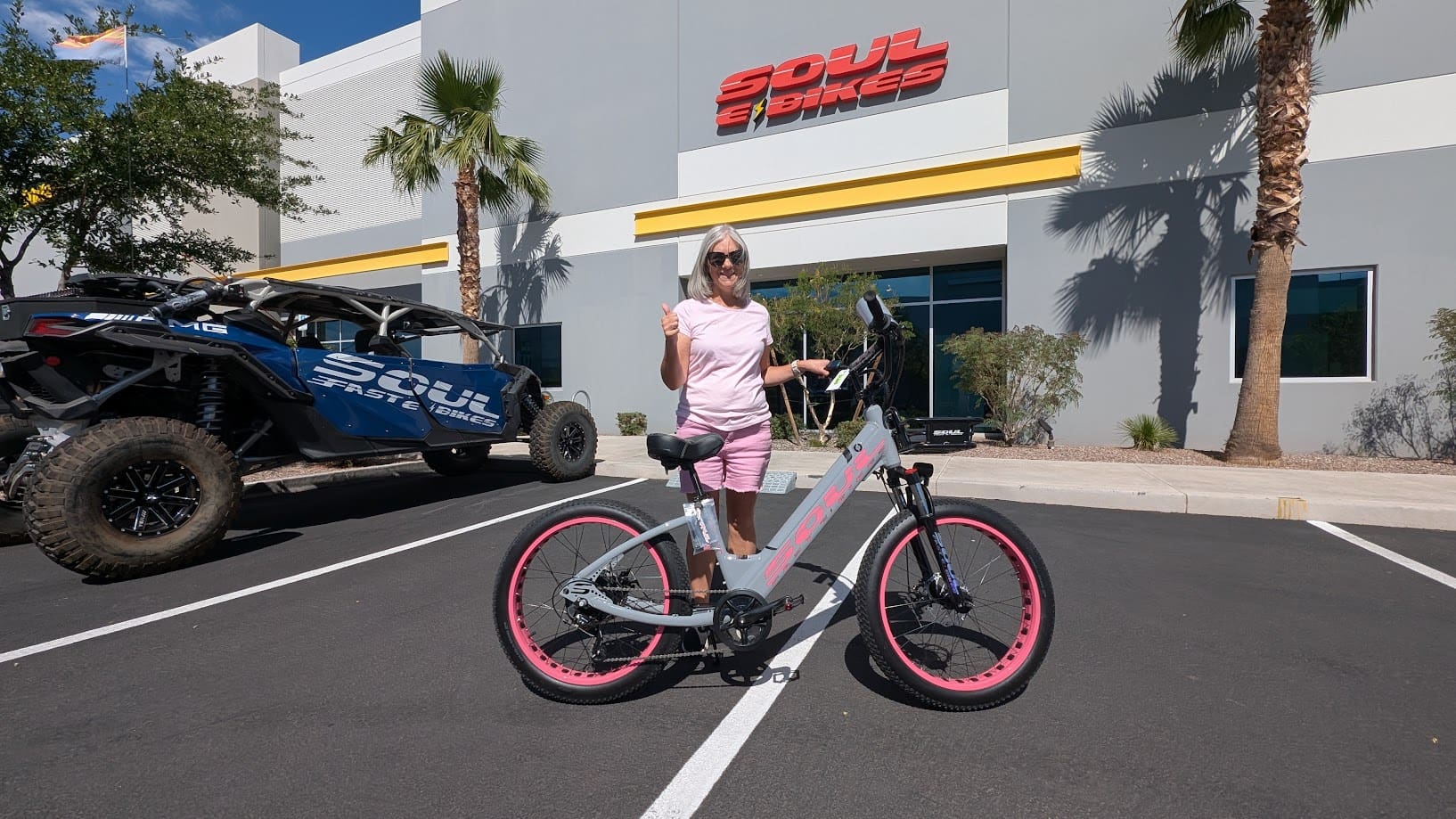 Person posing with bicycle outside Soul Bikes.