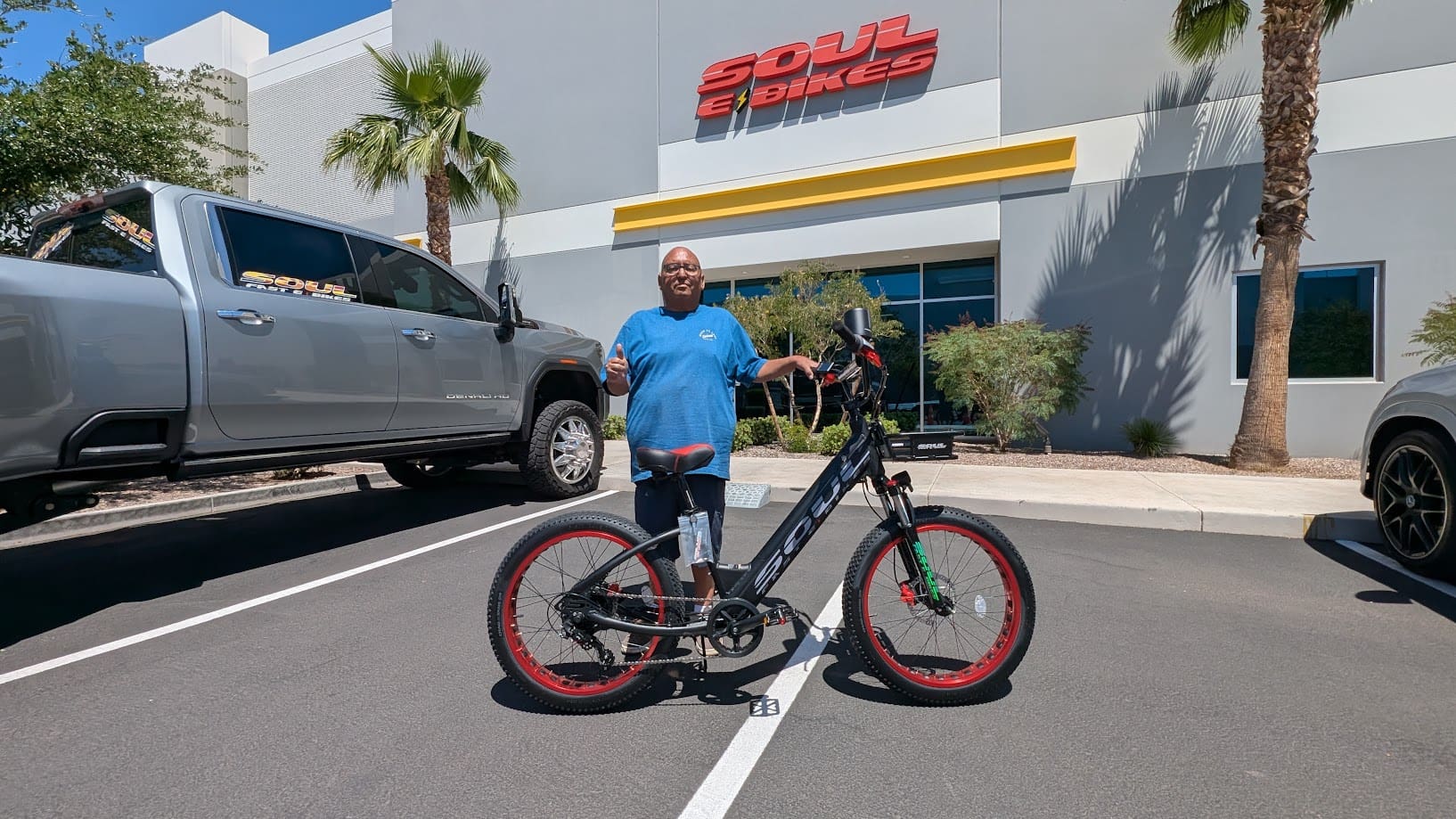 Man with bike outside Soul eBikes store.