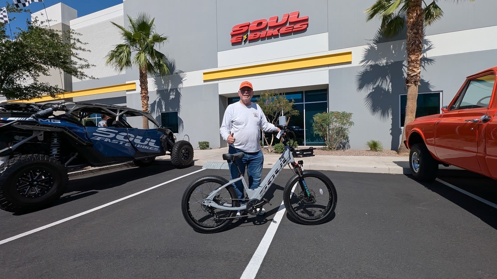 Man standing with bicycle outside Soul Bikes.