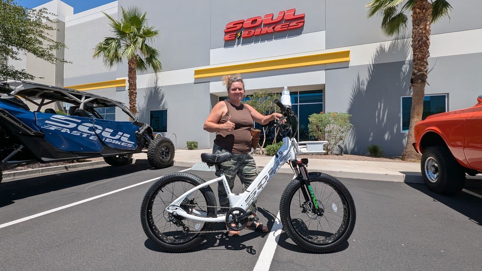 Person posing with bicycle outside Soul eBikes.
