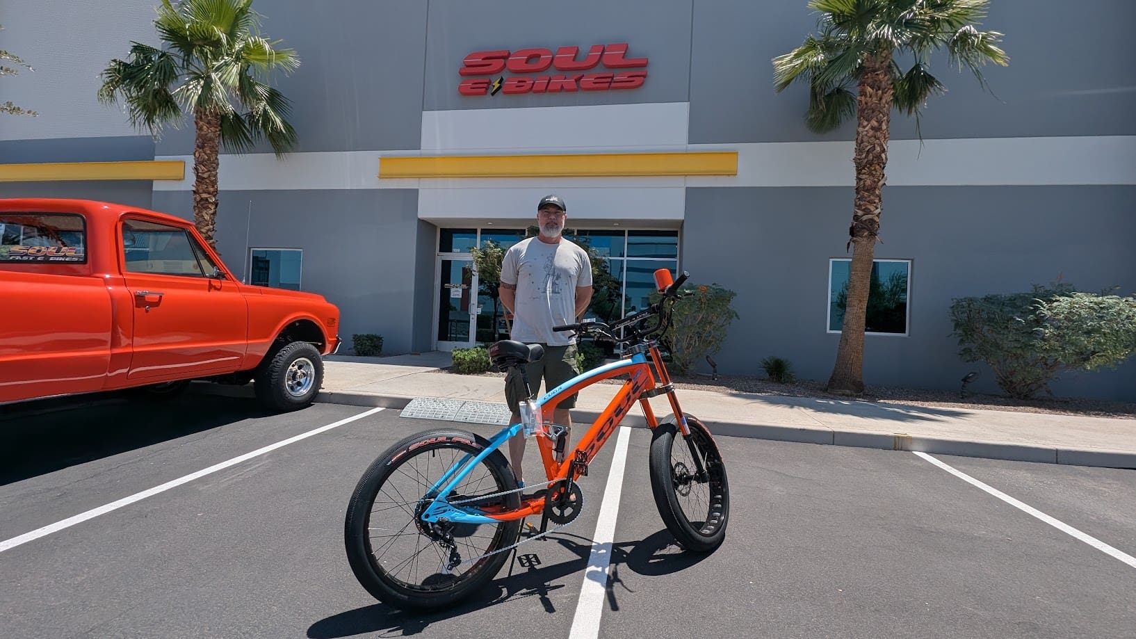 Man with bike outside Soul E Bikes store.