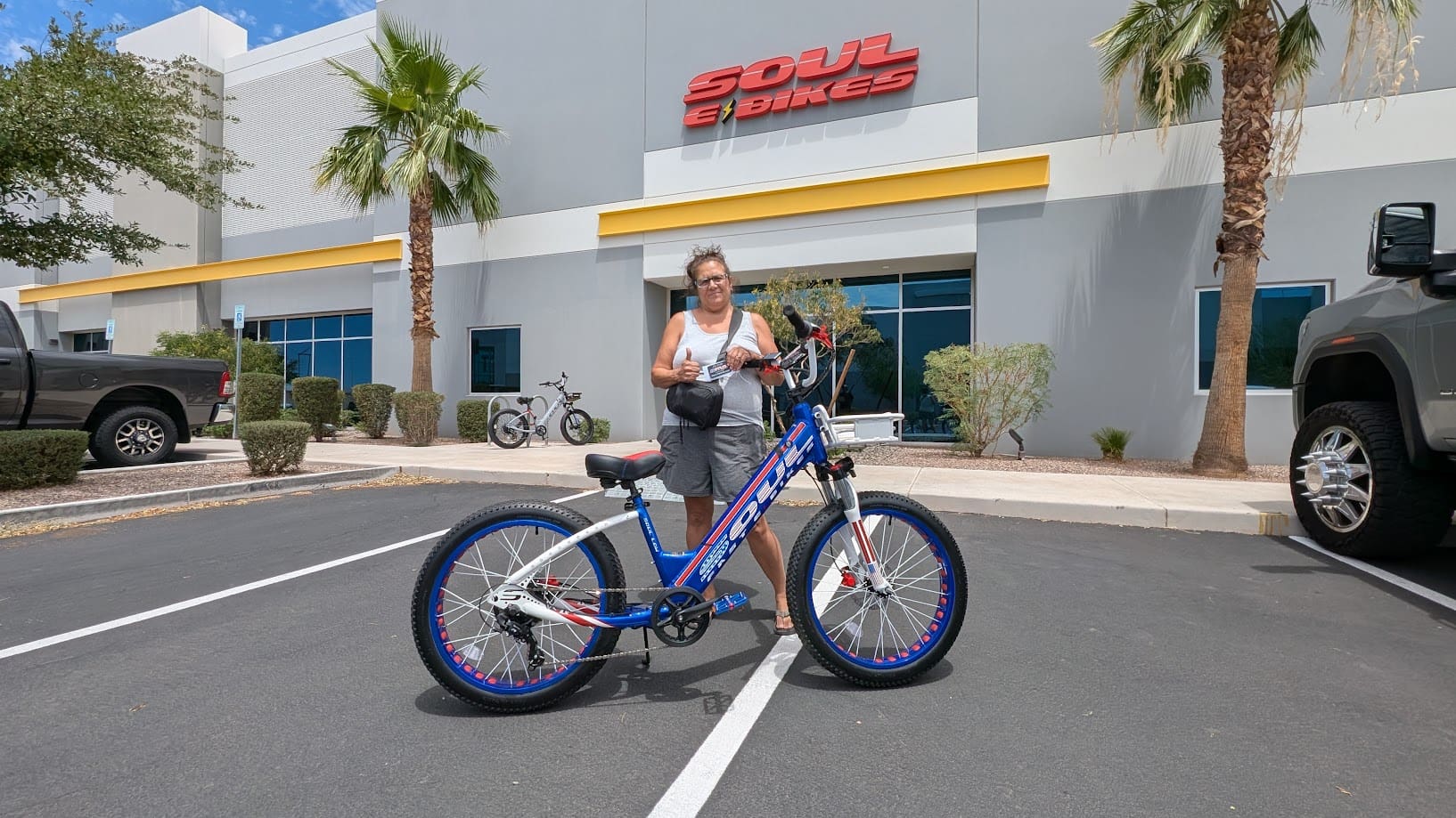 Person with bicycle outside Soul Bikes shop.