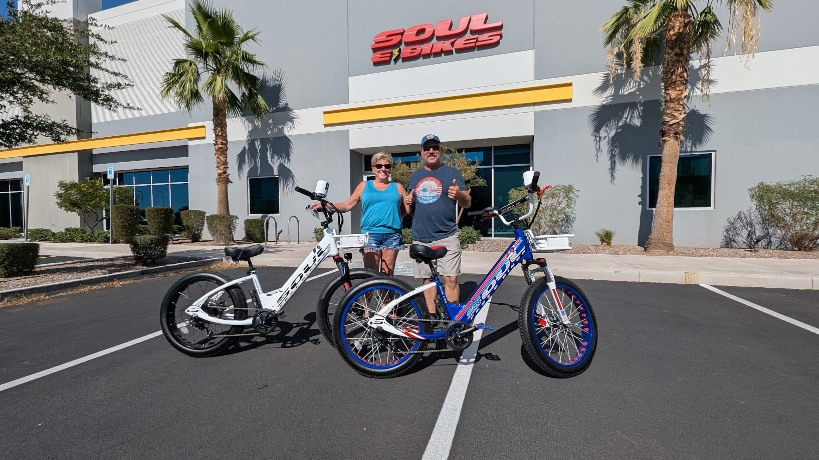 Two people with bikes outside Soul Bikes.