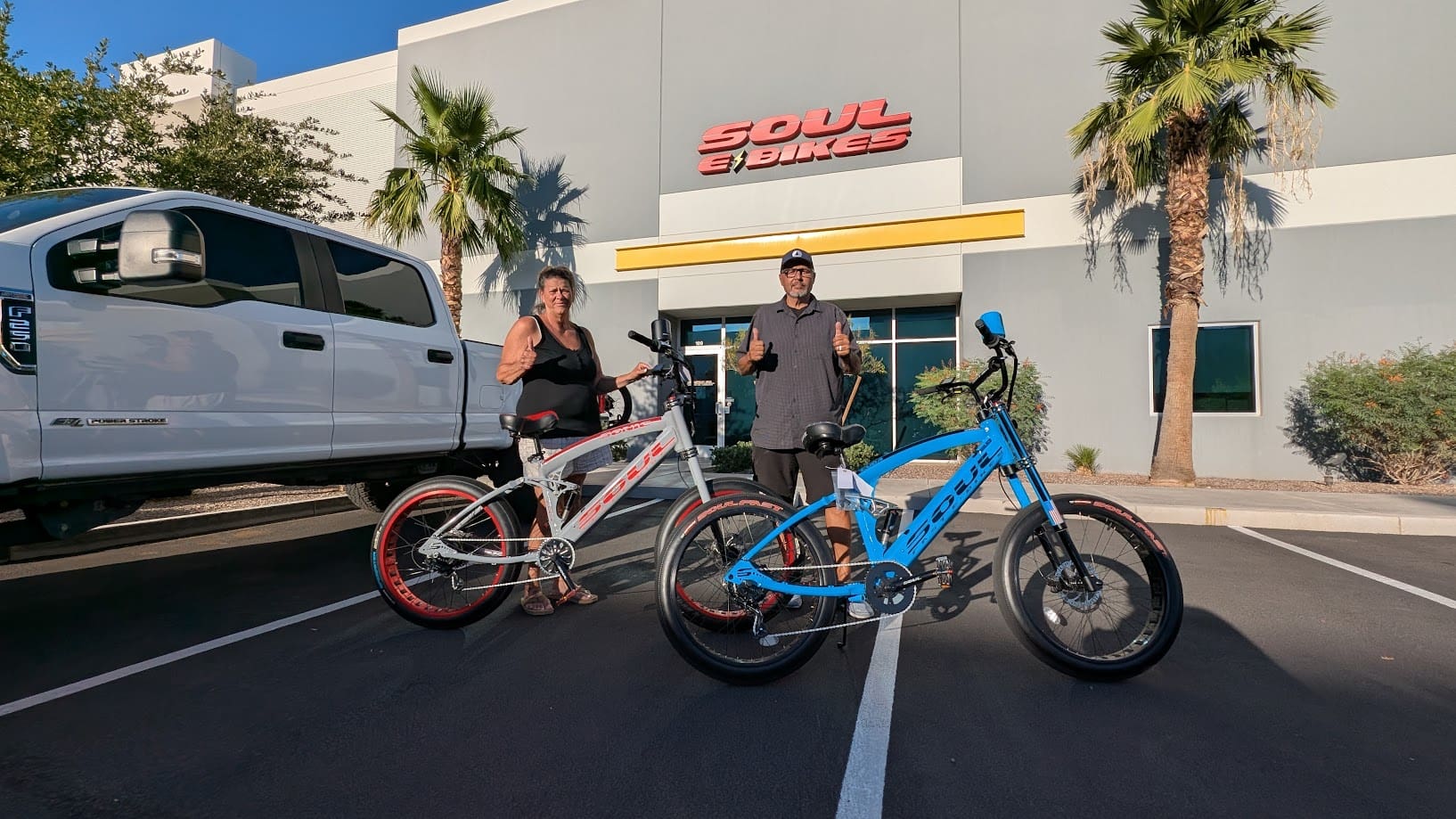Two people with bikes outside Soul Bikes.