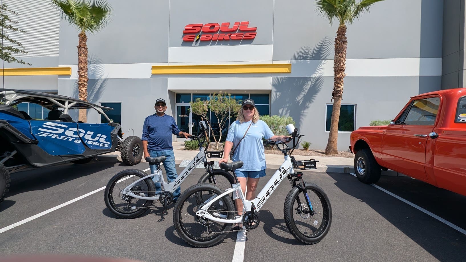 Two people with Soul electric bikes outside.