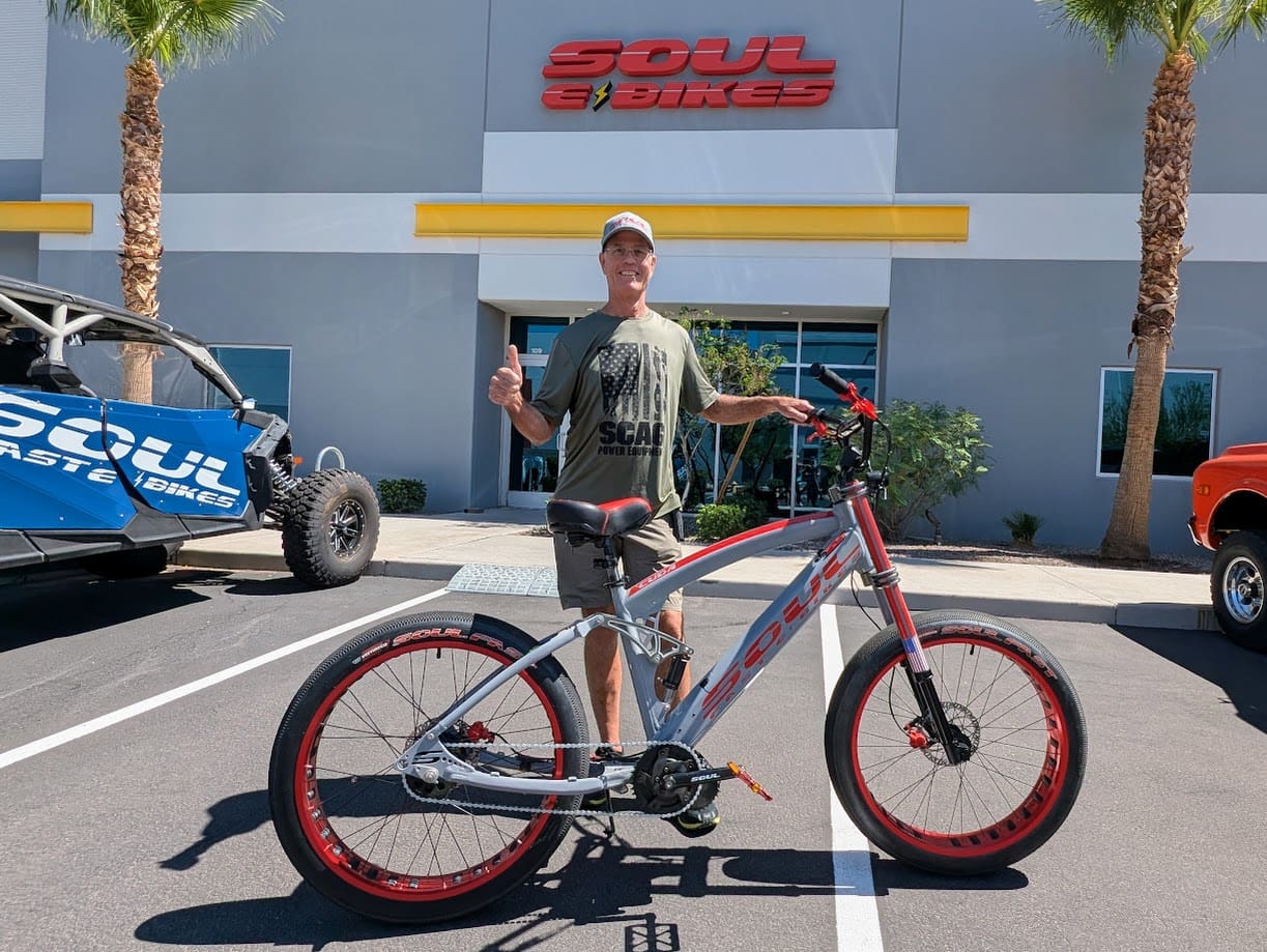 Man posing with bicycle outside Soul Bikes.