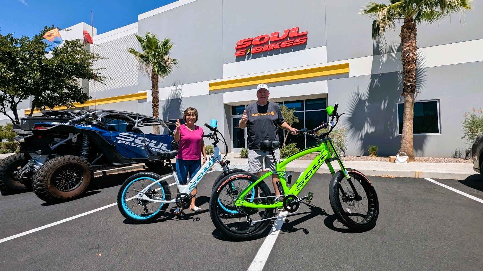 People with bicycles in front of store.