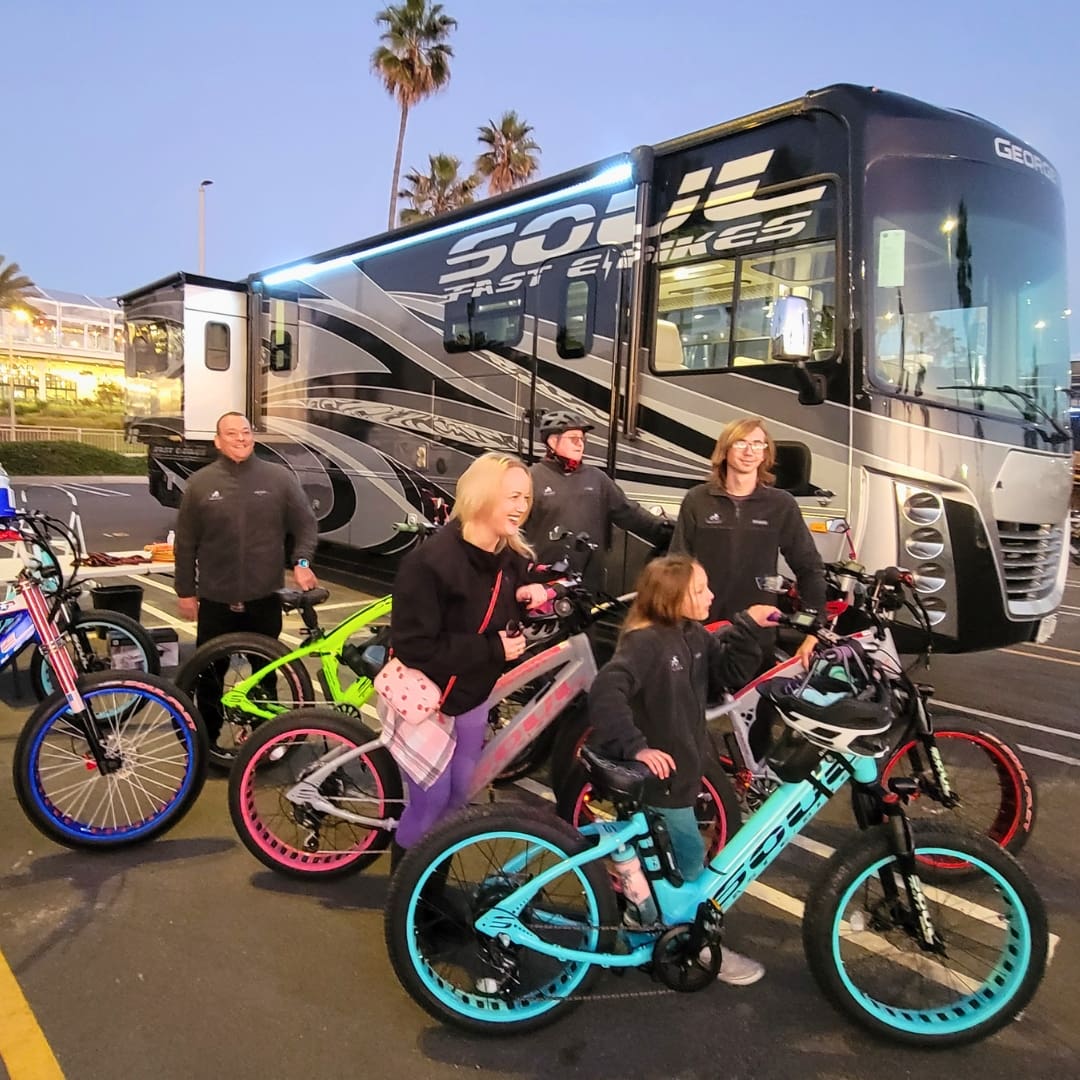 Group of people with colorful bicycles.