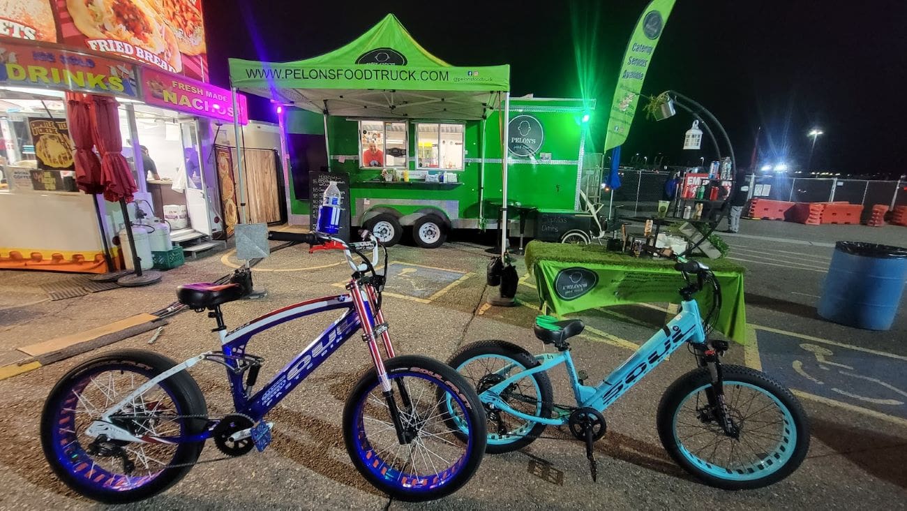 Bicycles parked near a vibrant food truck.