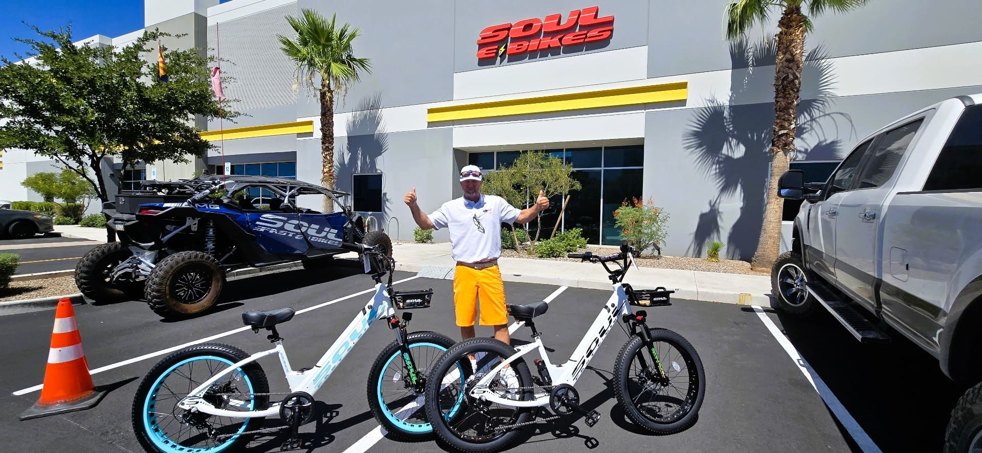 Person with electric bikes outside Soul Bikes store.