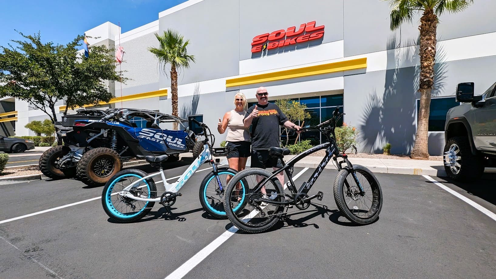 Two people with bicycles outside Soul Bikes.