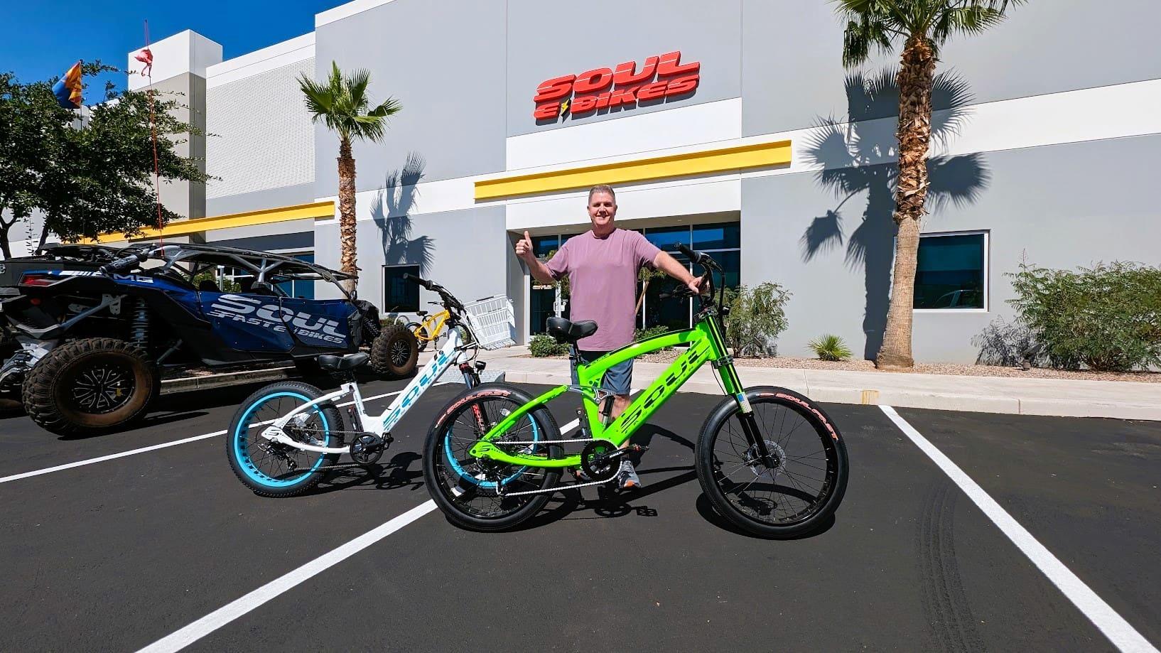 Man with bikes outside a bike store.