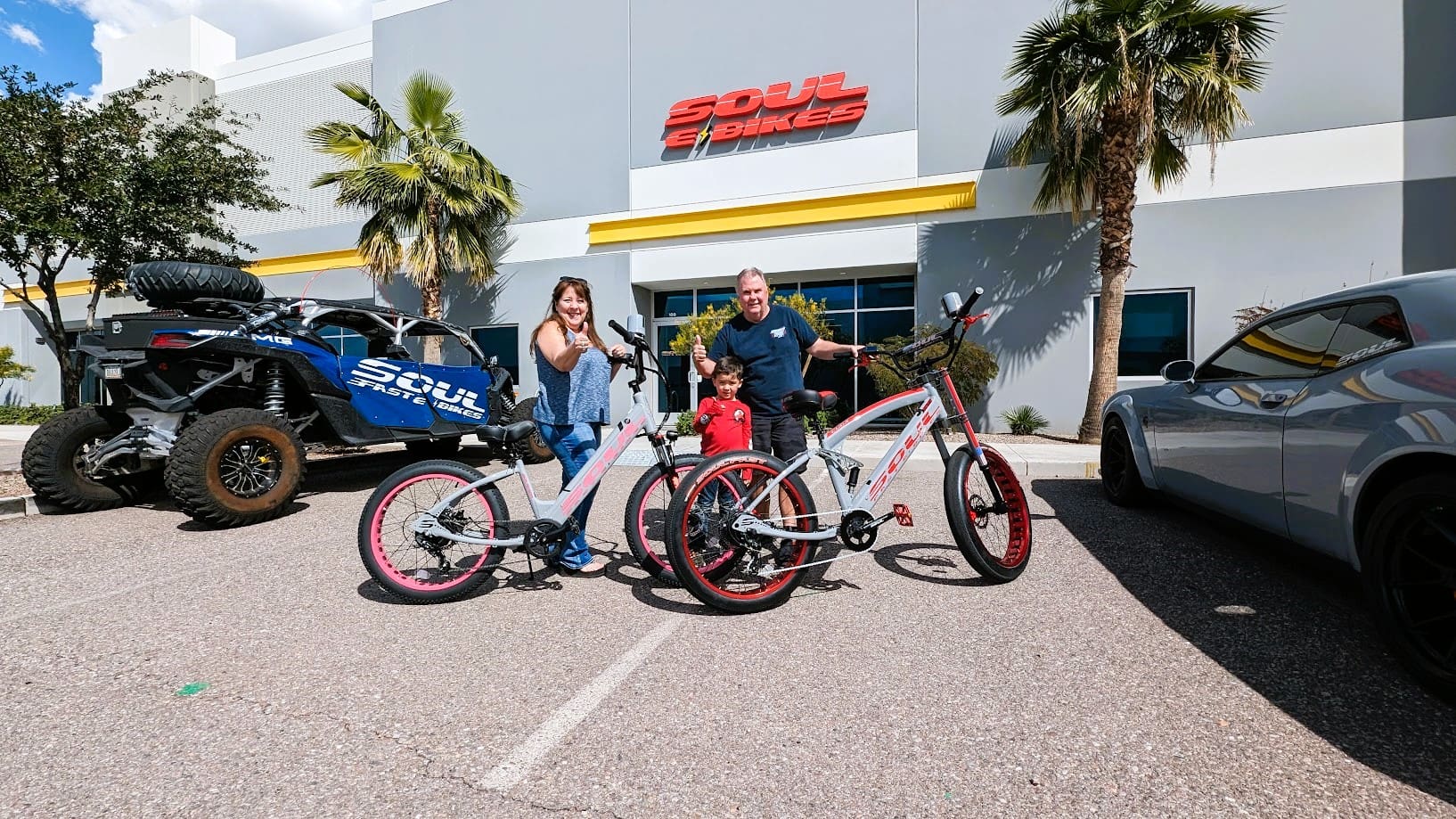 Family with bicycles outside Soul Bikes building.