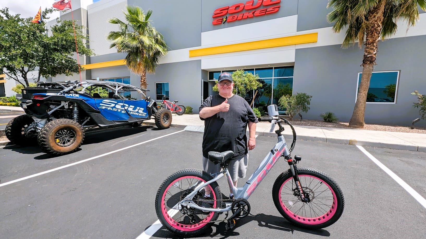 Man with bike outside Soul Bikes store.