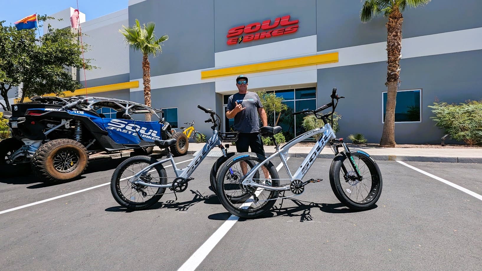 Man with two bikes outside Soul Bikes store.