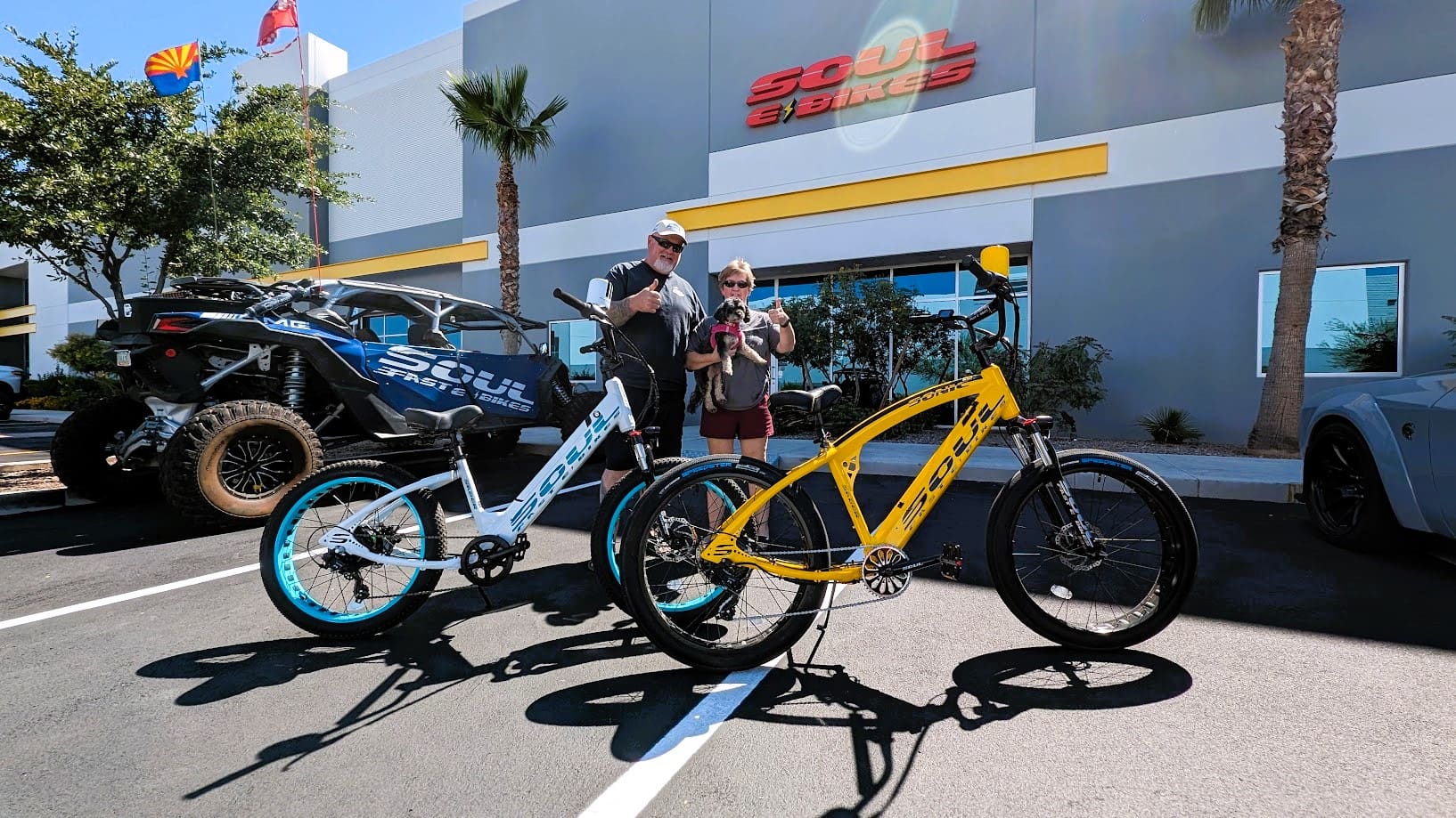 Two people with bicycles outside a store.