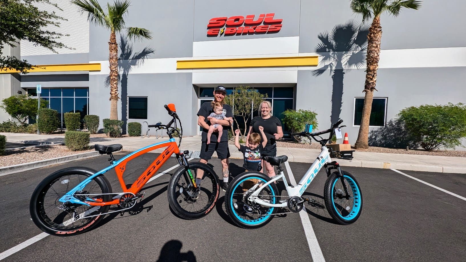 Family posing with bikes outside Soul Beach.