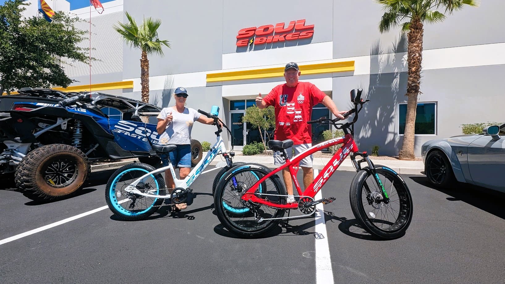 Two people with bicycles outside Soul Bikes.