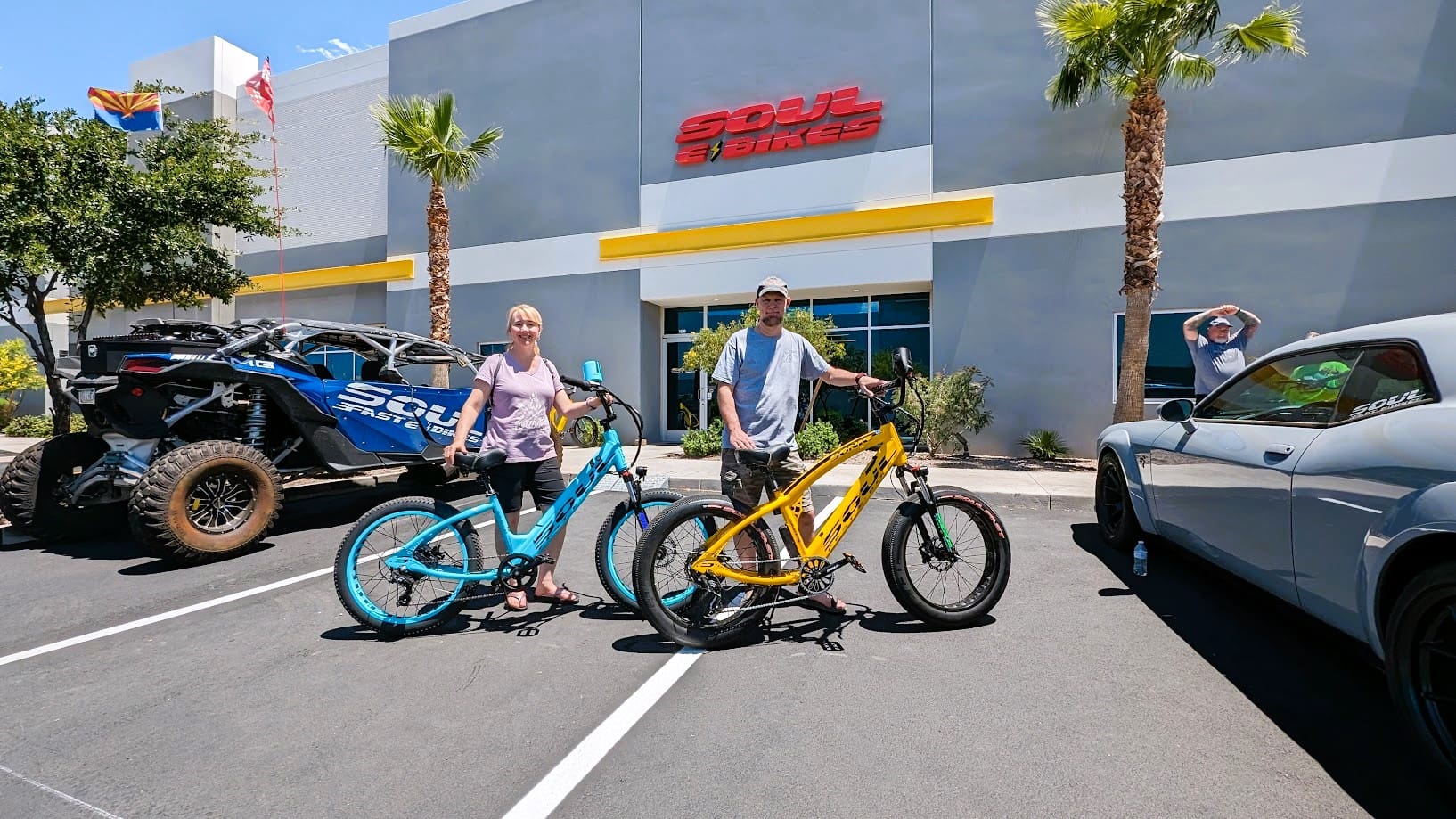 People with bikes outside a bike shop.