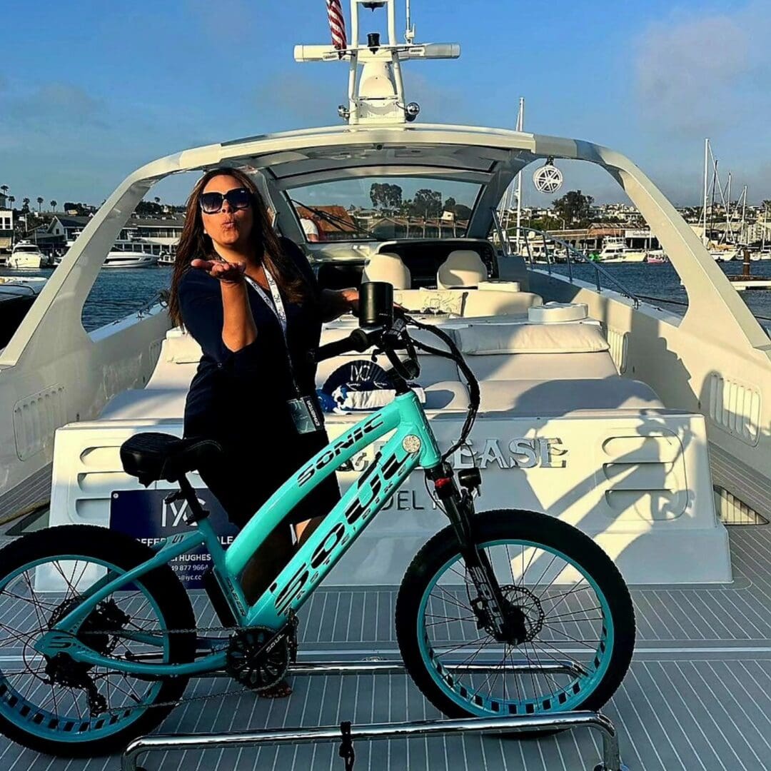 Woman on yacht with turquoise bicycle.