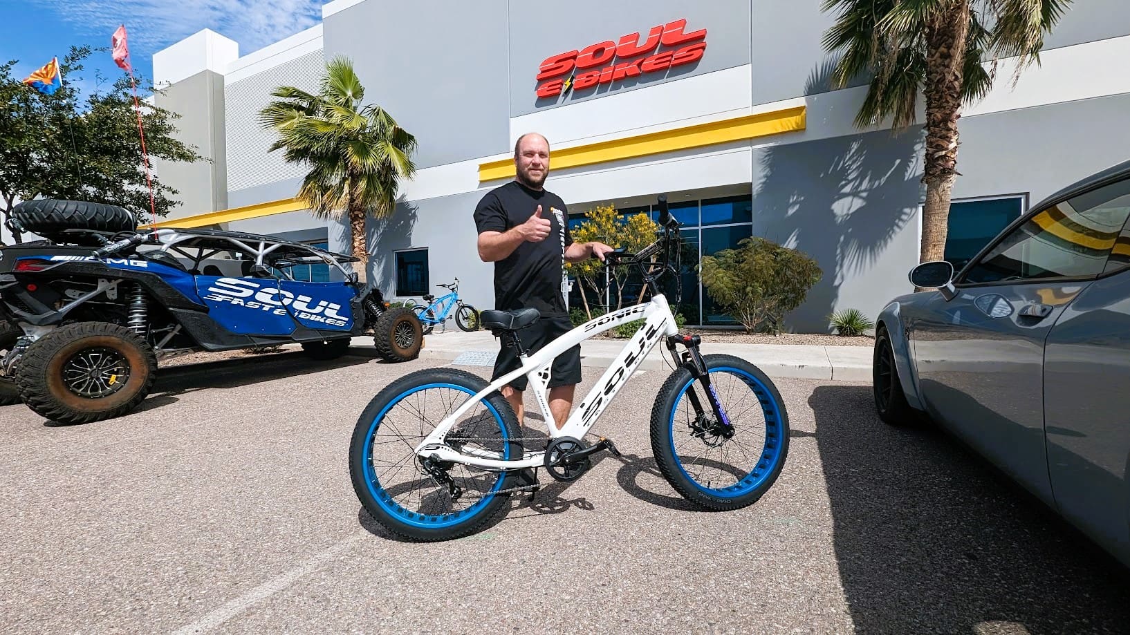 Person with bicycle outside a bike shop.