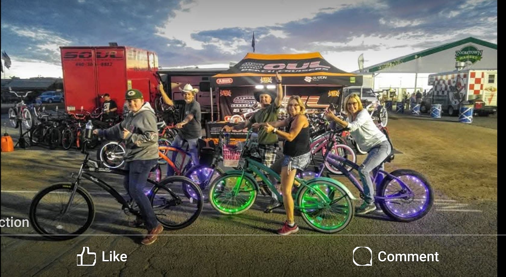 Group enjoying neon-lit bicycles at event.