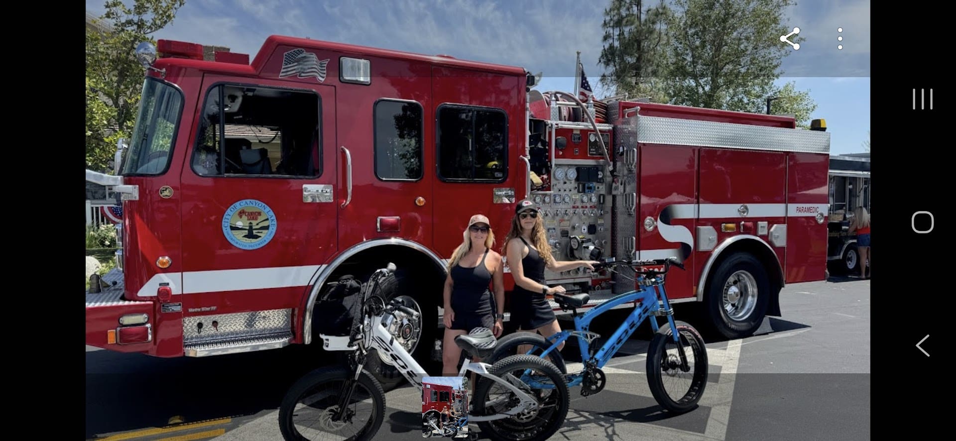 Fire truck with two people and bikes.